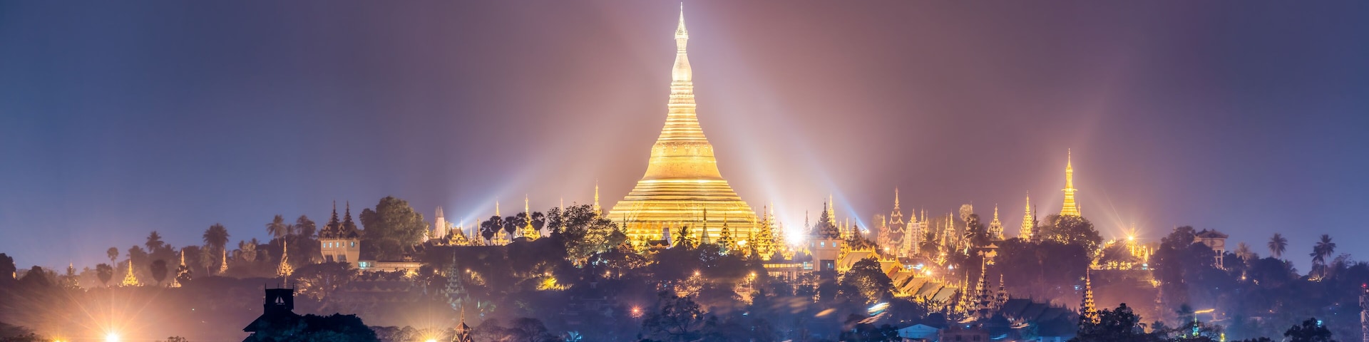 Panoramic view of the golden Shwedagon Pagoda at night, Yangon, Myanmar