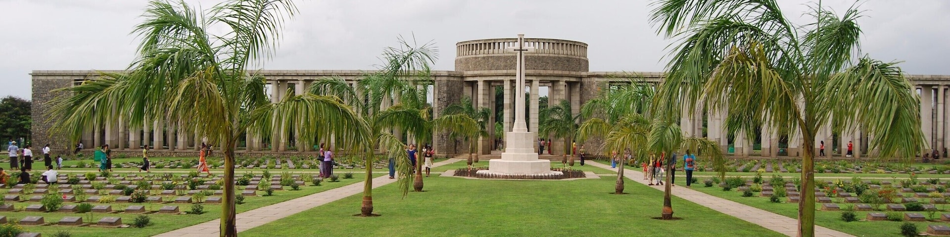 This place is known by locals as the war cemetery or the Allied cemetery. It is an incredibly well maintained cemetery honoring the soldiers who lost their lives in WWI and WWII. We were overwhelmed by the number of graves and the 27,000 other soldiers who were honored but unable to be buried. If you are in Yangon you should definitely make the trip to the cemetery.   
To get here we took the circle train out of Yangon Central Railway station to the stop Kyaikkale (one after the Golf Course stop). From that station we walked to the road and hailed a taxi. It took 4 or 5 to find someone who could speak enough English to take us there. We paid 8000 Kyat (appr. 8 USD) for the ride there, for him to wait, and for the ride back to the station. It takes about 15-20 minutes in the taxi to get there. The locals use the cemetery more like a park and were more interested in us than anything else. This was irritating but as tourism is so little still it is understandable. Entrance is free.