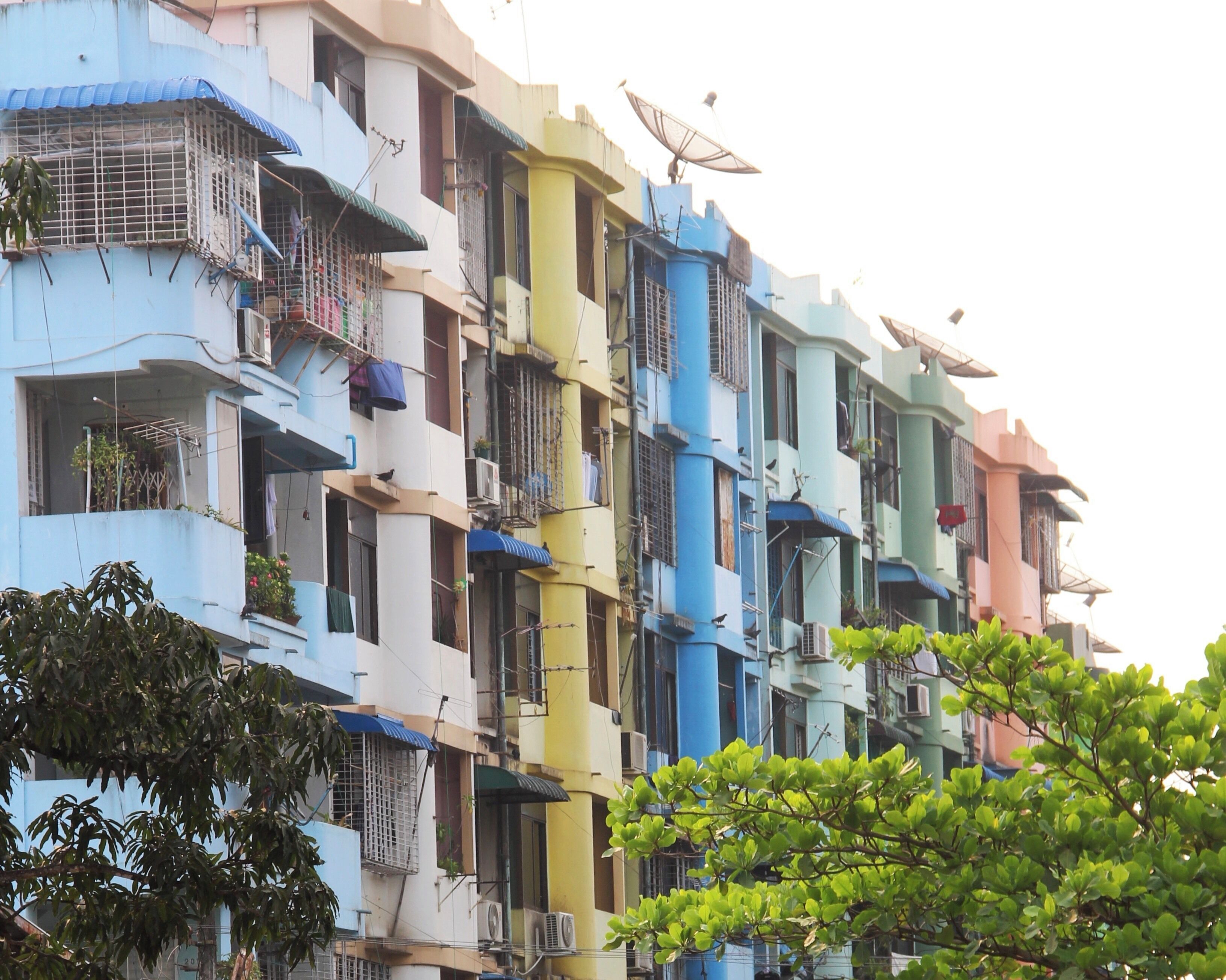 Myanmar flats - cute pastel shades overlooking the hustle and bustle of the streets below.
