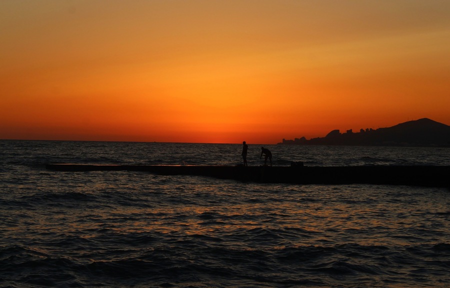 I took this on July 2nd in Sochi, Russia. More specifically in the Adler area. I had relaxing trip there :). I was mostly at the Black Sea beaches, but I did spend a day in the Caucasus Mountains! But the sunset moments were perhaps my favorite. They always looked so serene at the beach :). And a very peaceful time! Quite a contrast, too, from the crowded beach days. Even in the morning it was already crowded. People wanted to go before the high temperatures came. But at evening it cooled down, but also most of the people left. There was still enough people though to give it a lovely atmosphere! Here is one of those shots!