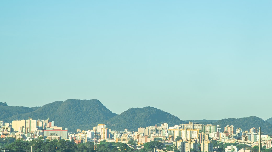 A cityscape with a mountain range in the background.