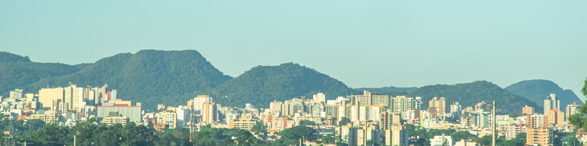 A cityscape with a mountain range in the background.