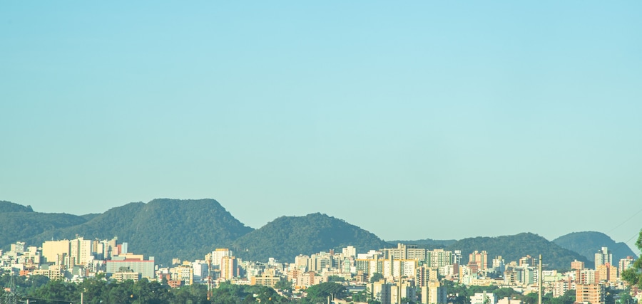 A cityscape with a mountain range in the background.