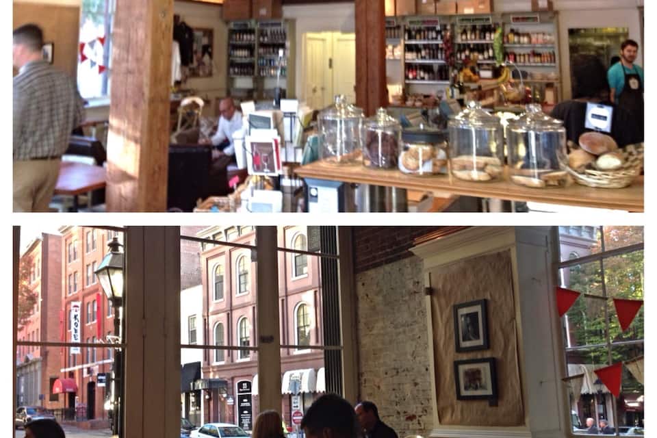 A cozy cafe with wooden interiors and a view of the street outside.
