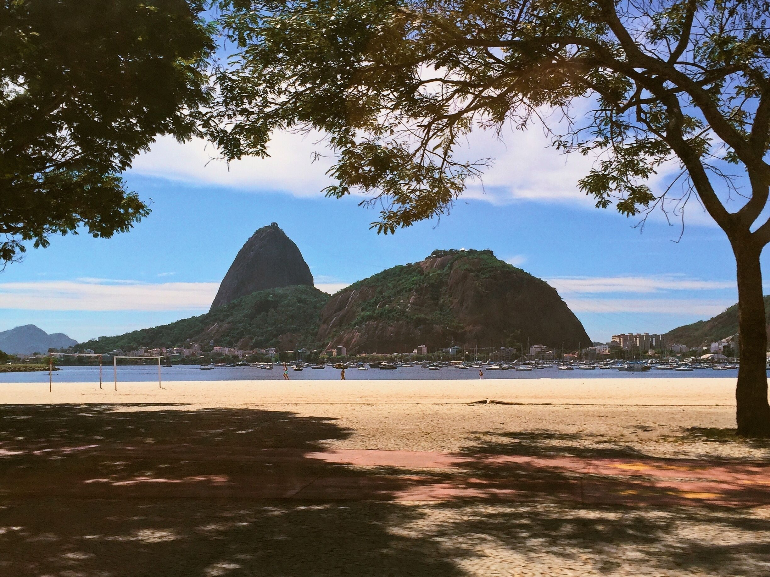 A beach with a prominent mountain in the background.
