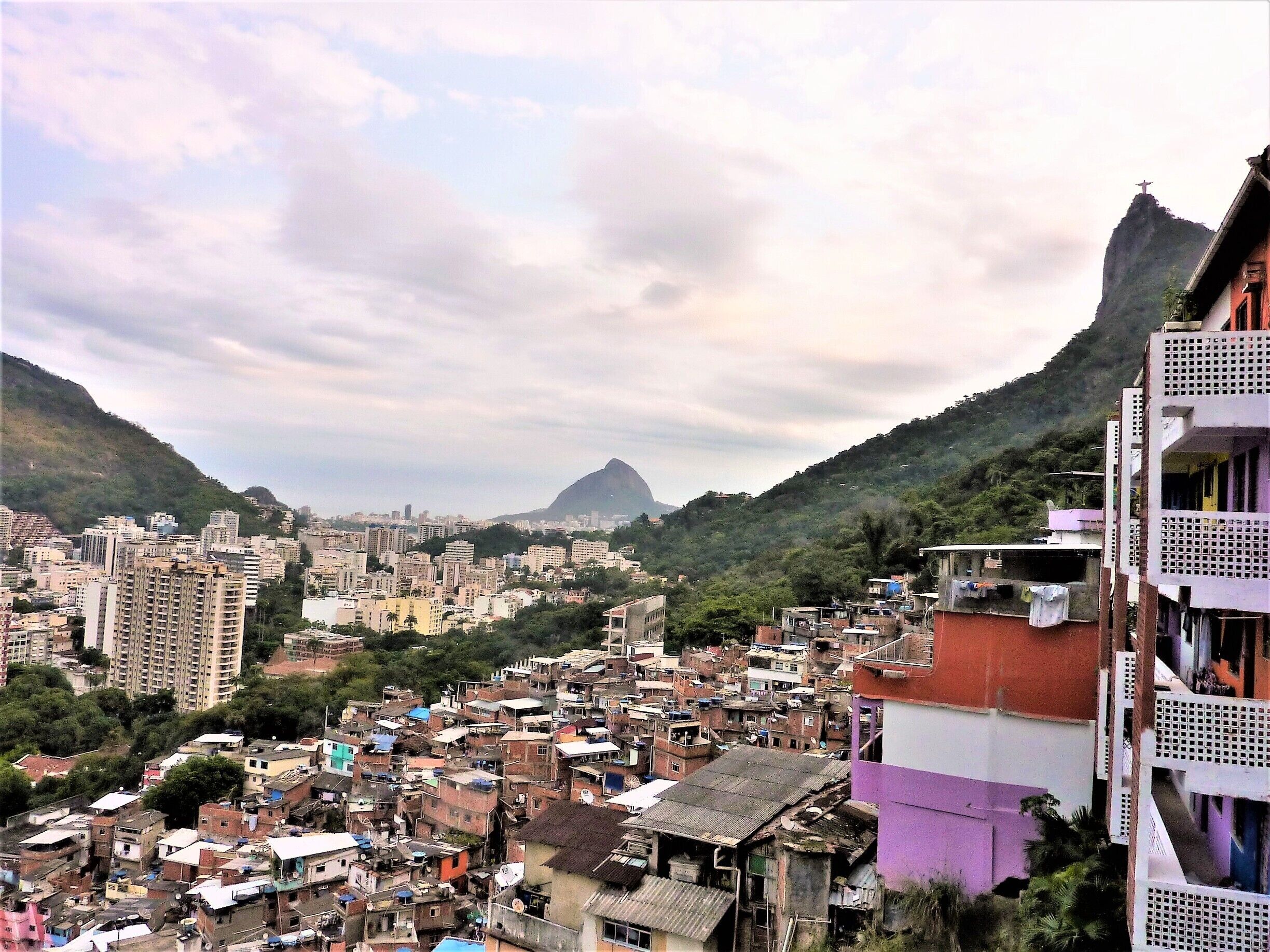 The diversity of Rio de Janeiro. In the distance, a wonder of the world over looking the vibrant city and the favelas, An amazing tour guide will take you through the history of Santa Marta and its community. #UrbanJungle