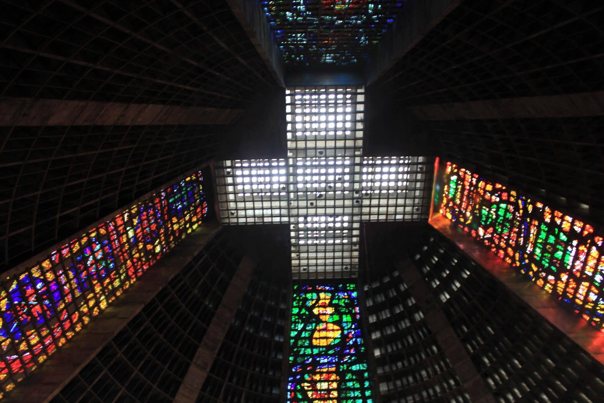 The Rio Cathedral is probably one of the most interesting churches I've ever been to. From the outside it looks like a spaceship. This is the inside, with a very, very tall ceiling that forms a cross out of light. 
#Merch #Rio #lifeatexpedia