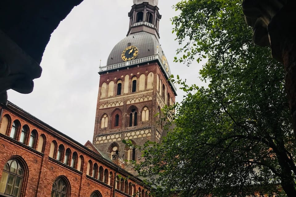 A historic building with a clock tower and arched windows.
