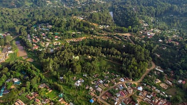 A mountainous landscape with scattered houses and a winding river.