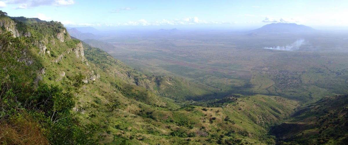 A mountainous landscape with steep cliffs and a valley.