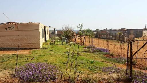 A pleasant home built out of corrugated iron set amidst a beautiful garden in a rural suburb just outside Johannesburg, South Africa. #lifeatexpedia