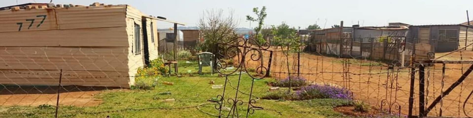 A pleasant home built out of corrugated iron set amidst a beautiful garden in a rural suburb just outside Johannesburg, South Africa. #lifeatexpedia