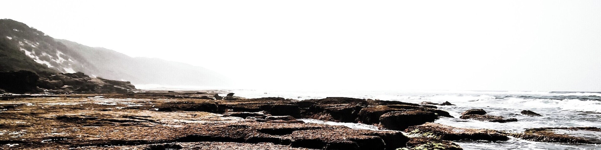 Cape Vidal is located on the coastline of South Africa. The waves crashed against the rocks leaving tide pools for the local Ghost crabs