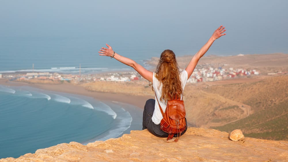 Woman tourist looking at panoramic Morocco coast- Imsouane