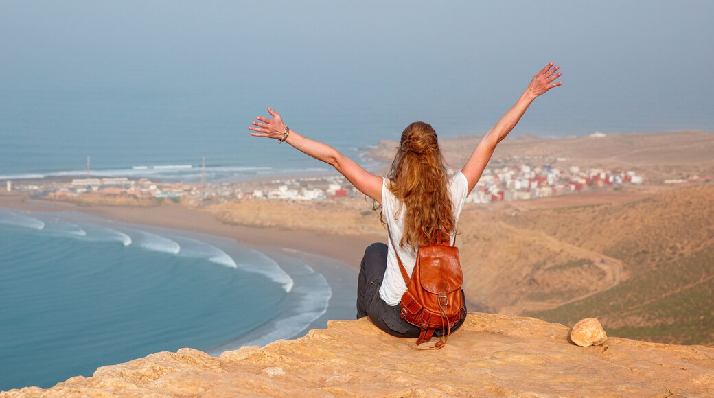 Woman tourist looking at panoramic Morocco coast- Imsouane