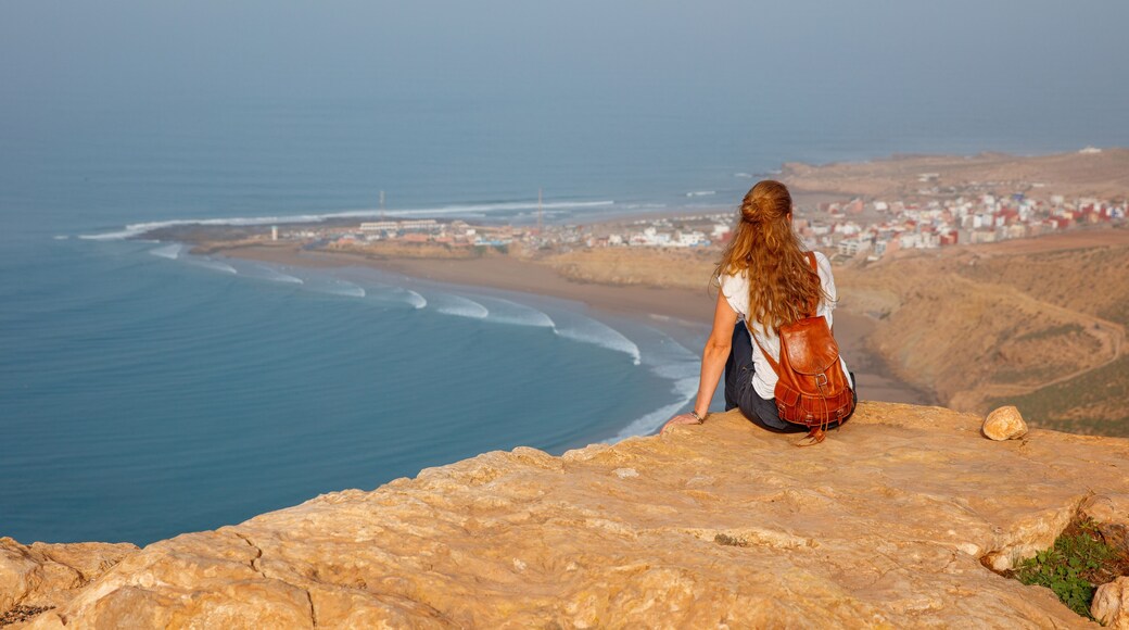 Woman tourist looking at Morocco coast- Imsouane