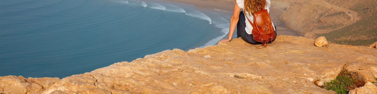 Woman tourist looking at Morocco coast- Imsouane
