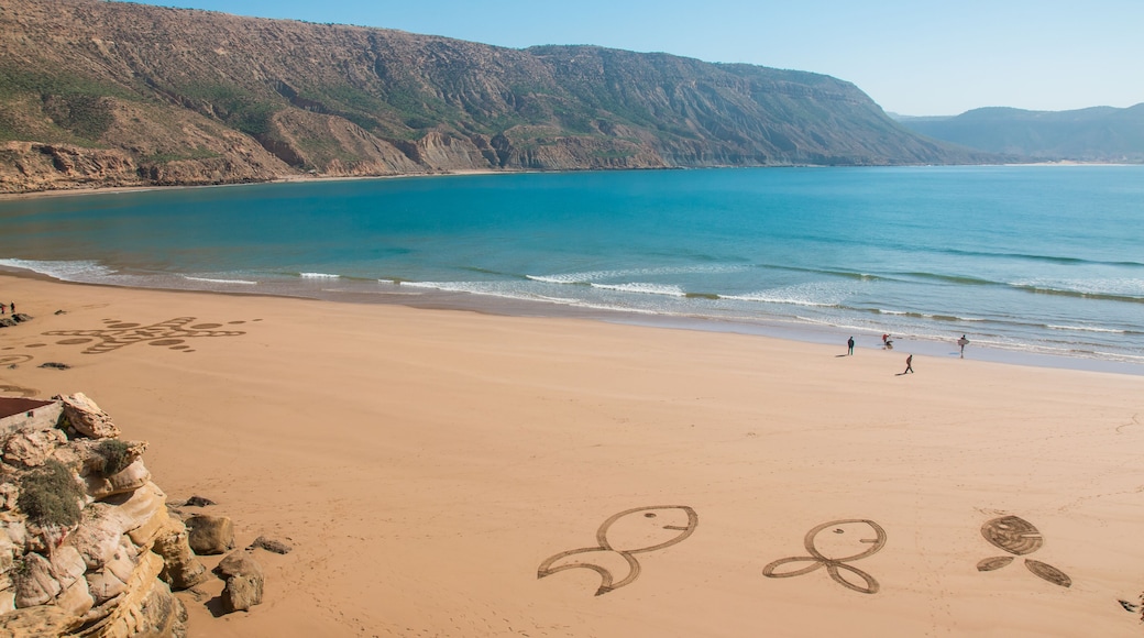 Figures in sand on the beach of Imsouane Morocco