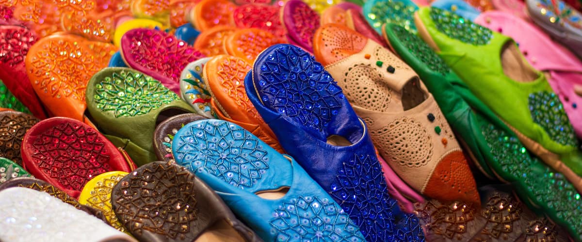 A variety of colorful, intricately designed slippers.