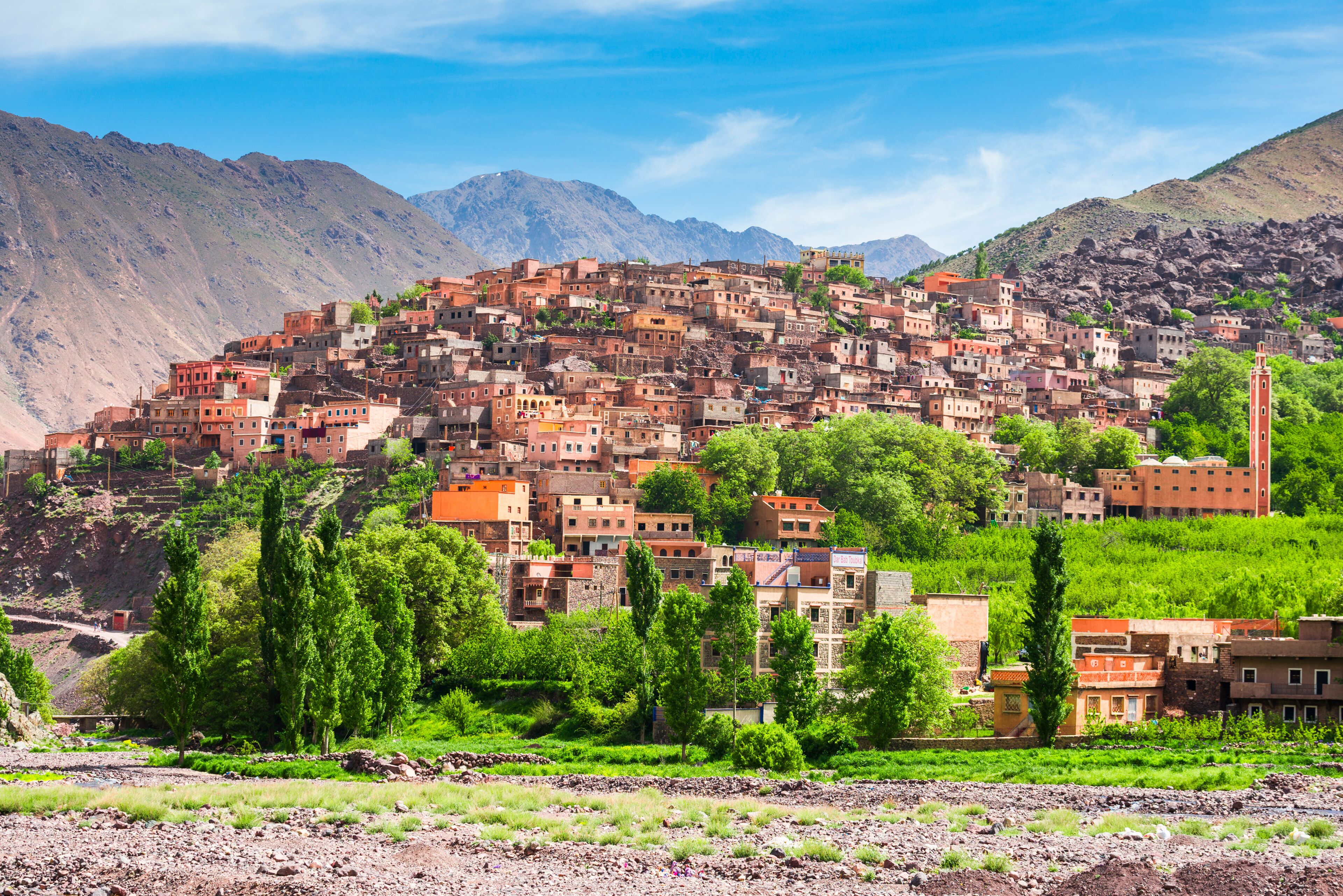 A terraced village with mountains in the background.