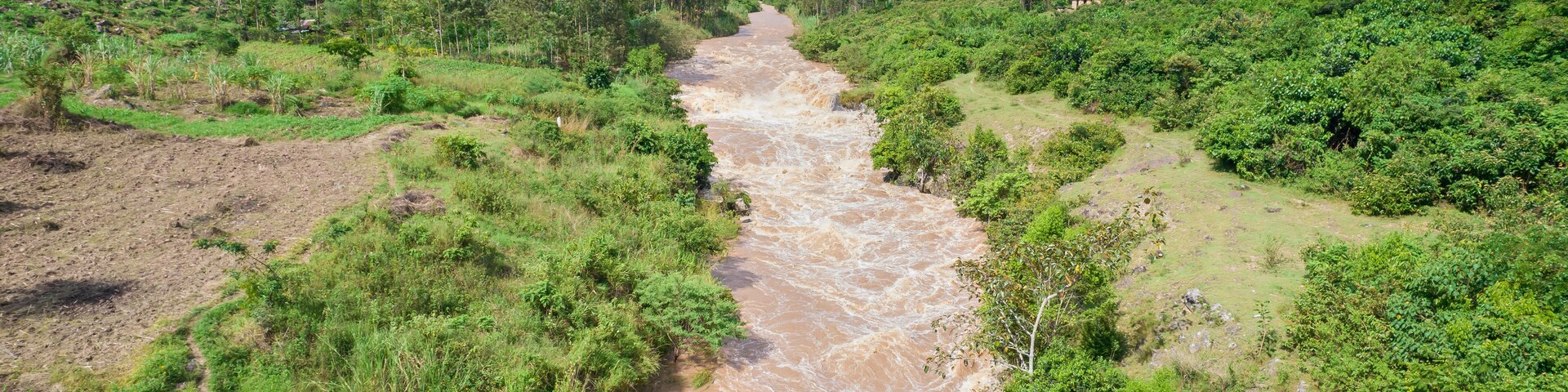 Aerial view of the lush and serene River Yala flowing through the tranquil landscape with greenery and trees, Sinaga, Kenya.