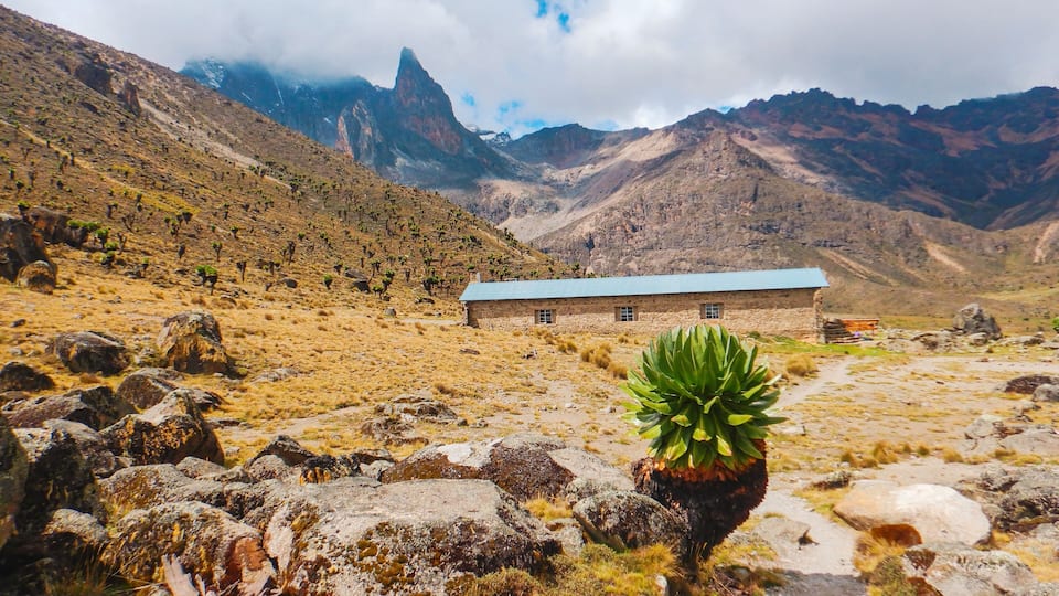 A cabin against a mountain background on Naro Moru route in Mount Kenya National Park, Kenya