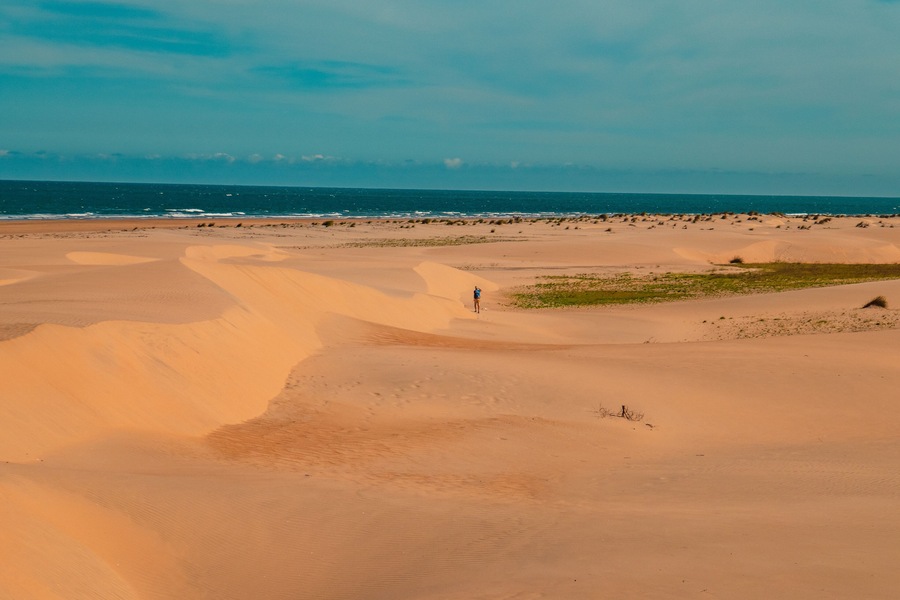 A tourist having fun on the Mambrui sand dunes in Mambrui Beach in Malindi, Kenya