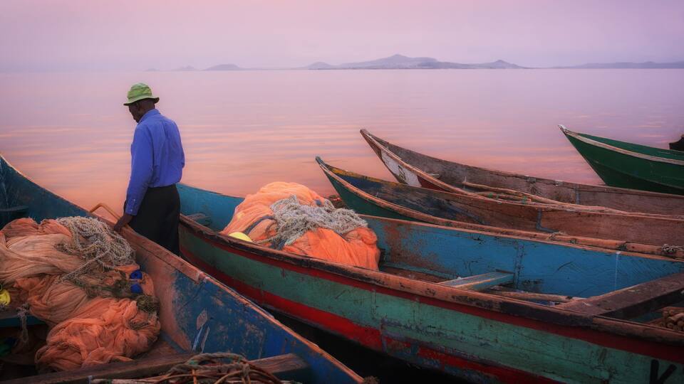 Colorful scenic sunset with fishing boats in the foreground on Mfangano Island, Lake Victoria, Kenya