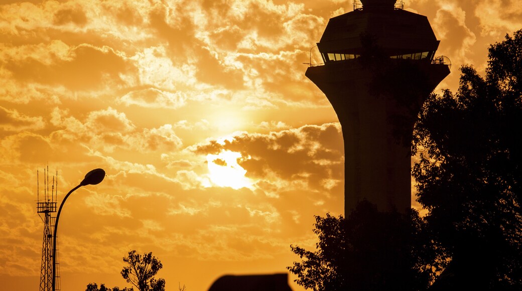 Nairobi, Kenya - 26 August 2014: View of the control tower silhouetted against a fiery sunset, with golden clouds painting the sky above Embakasi.