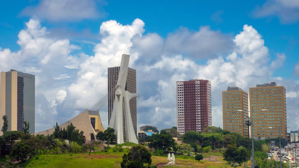 The modern skyline of the plateau district of Abidjan with St. Paul Cathedral in the foreground Abidjan, Côte d'ivoire (Ivory Coast), West Africa