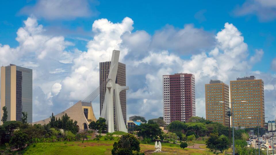 The modern skyline of the plateau district of Abidjan with St. Paul Cathedral in the foreground Abidjan, Côte d'ivoire (Ivory Coast), West Africa