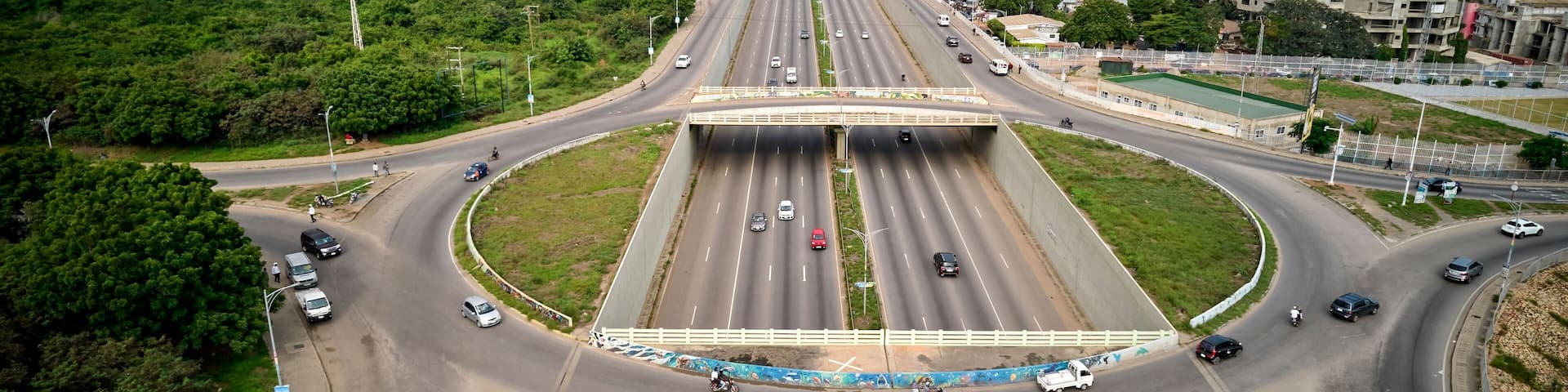 Bird's eye view of the Achimota forest with highway traffic on a roundabout