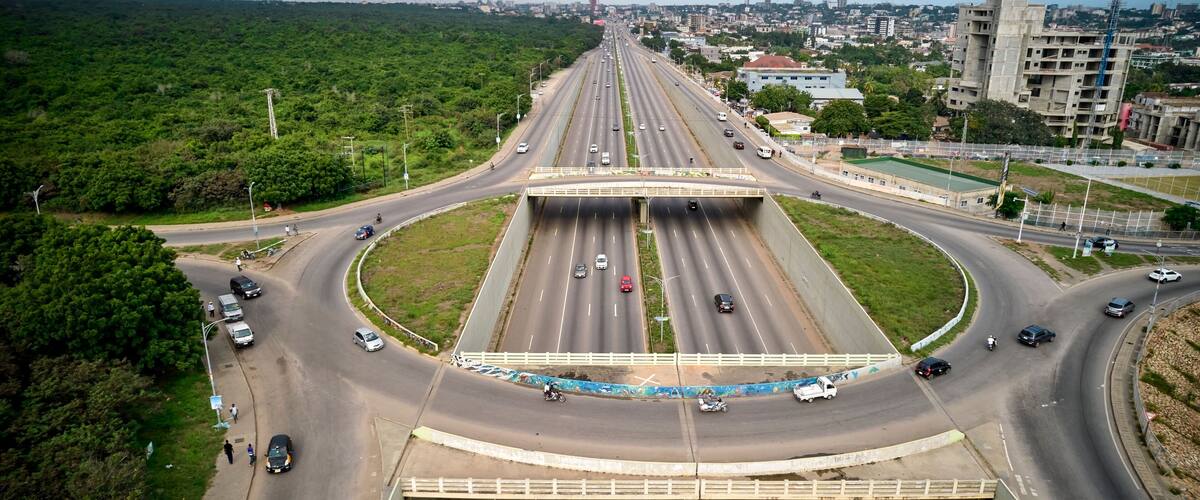 A multi-level highway interchange with several lanes and vehicles.