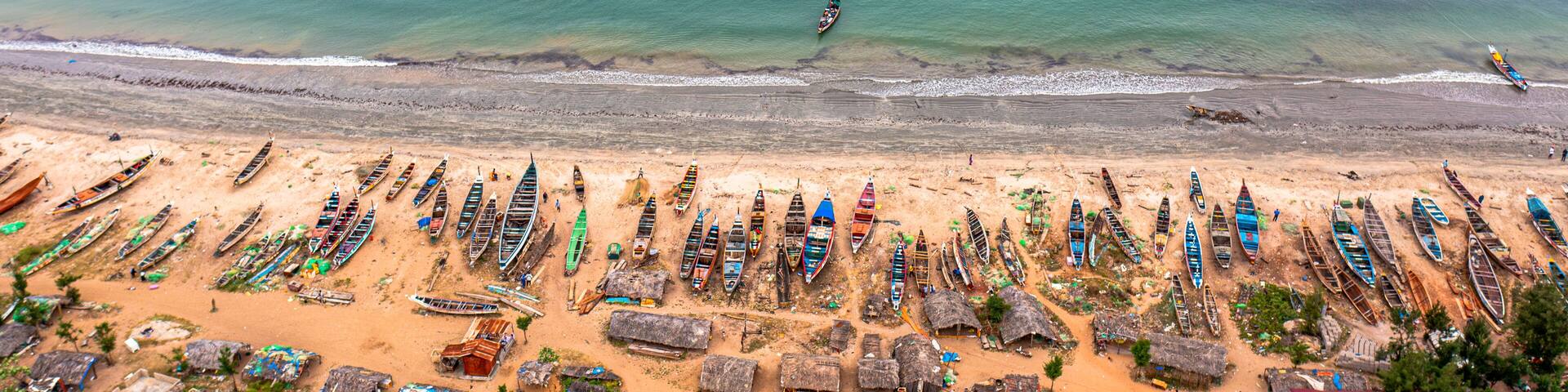 Aerial view of brufut fish market with fishing boats and sandy beach, Banjul, Gambia.