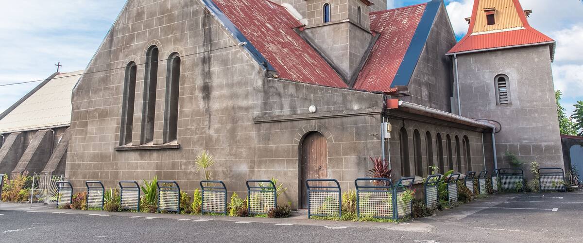 A church with a red roof and a steeple.