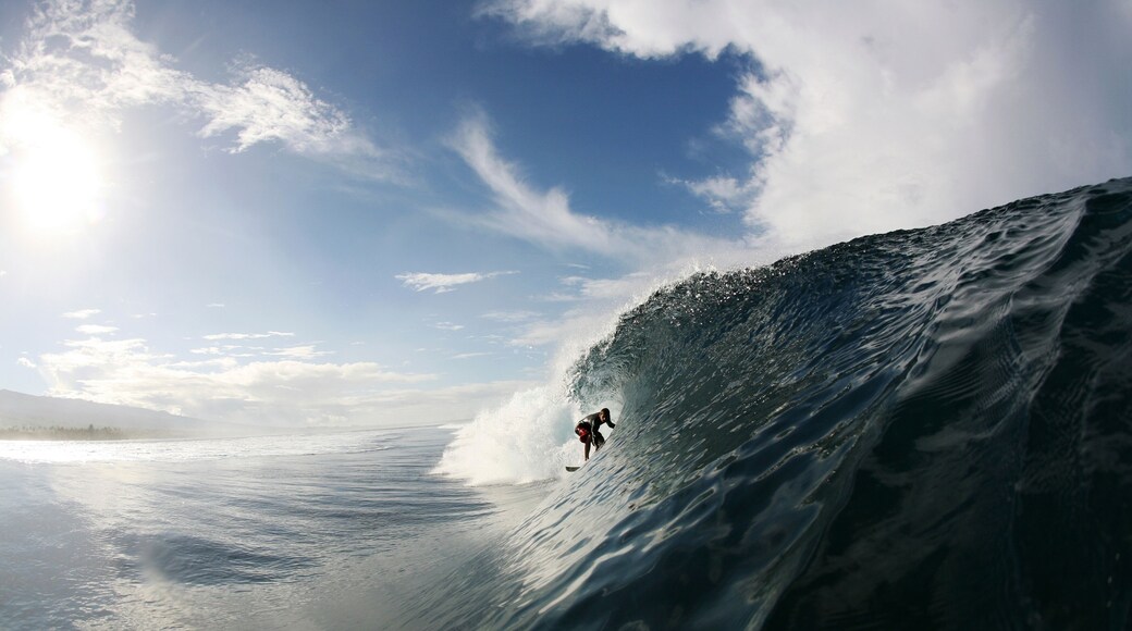 A surfer enters a barrel wave at Maninoa, Upolu, Samoa.