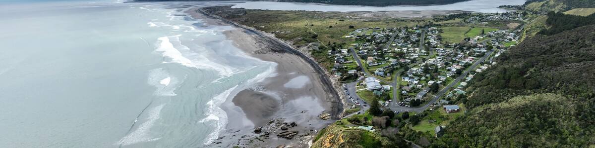 Beach, township and the river mouth of the Waikato River in Port Waikato, Waikato, New Zealand.