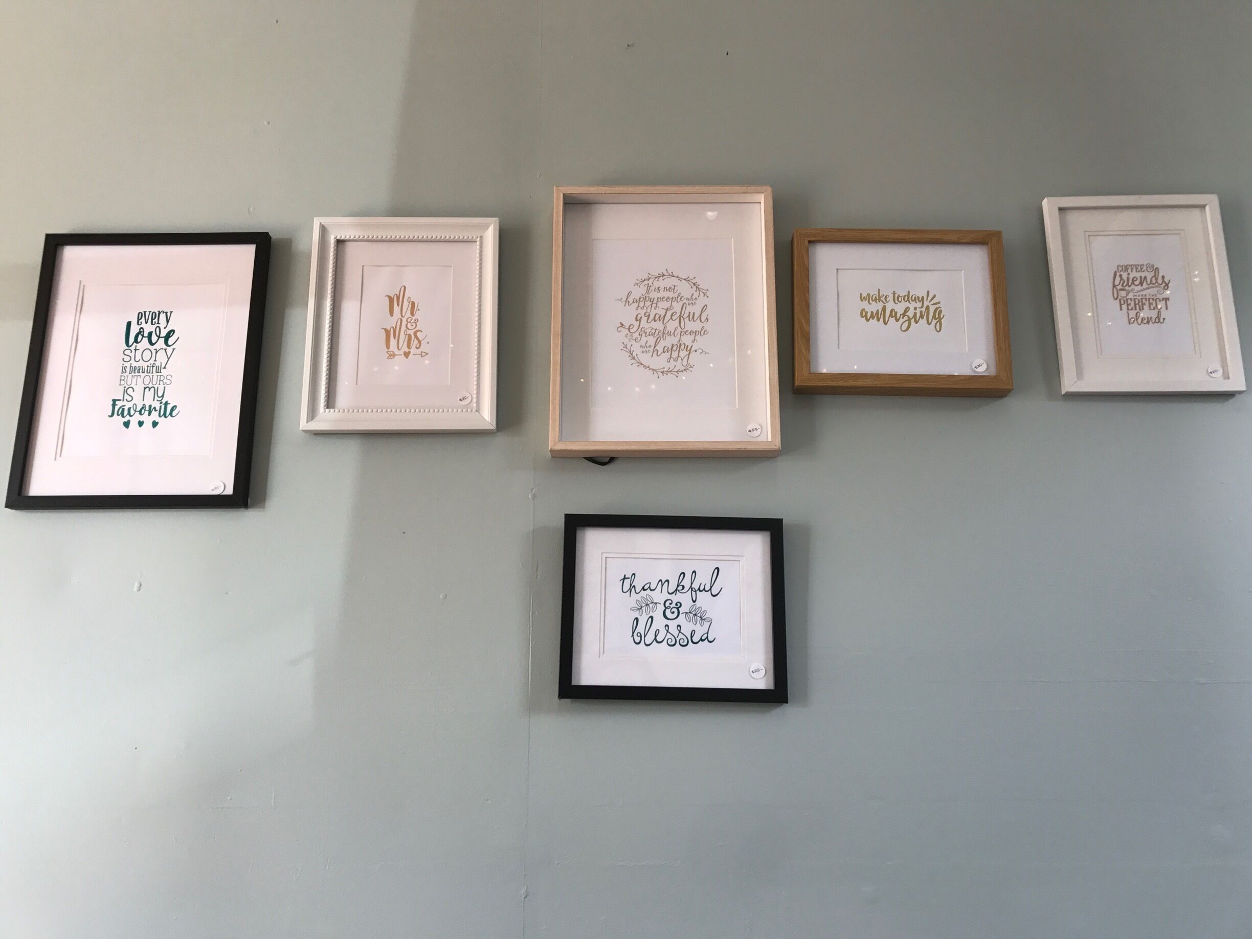 Six framed inspirational quotes on a wall.