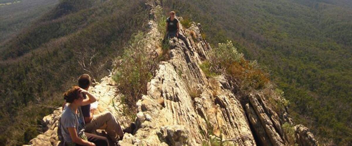 A rocky ridge with hikers.