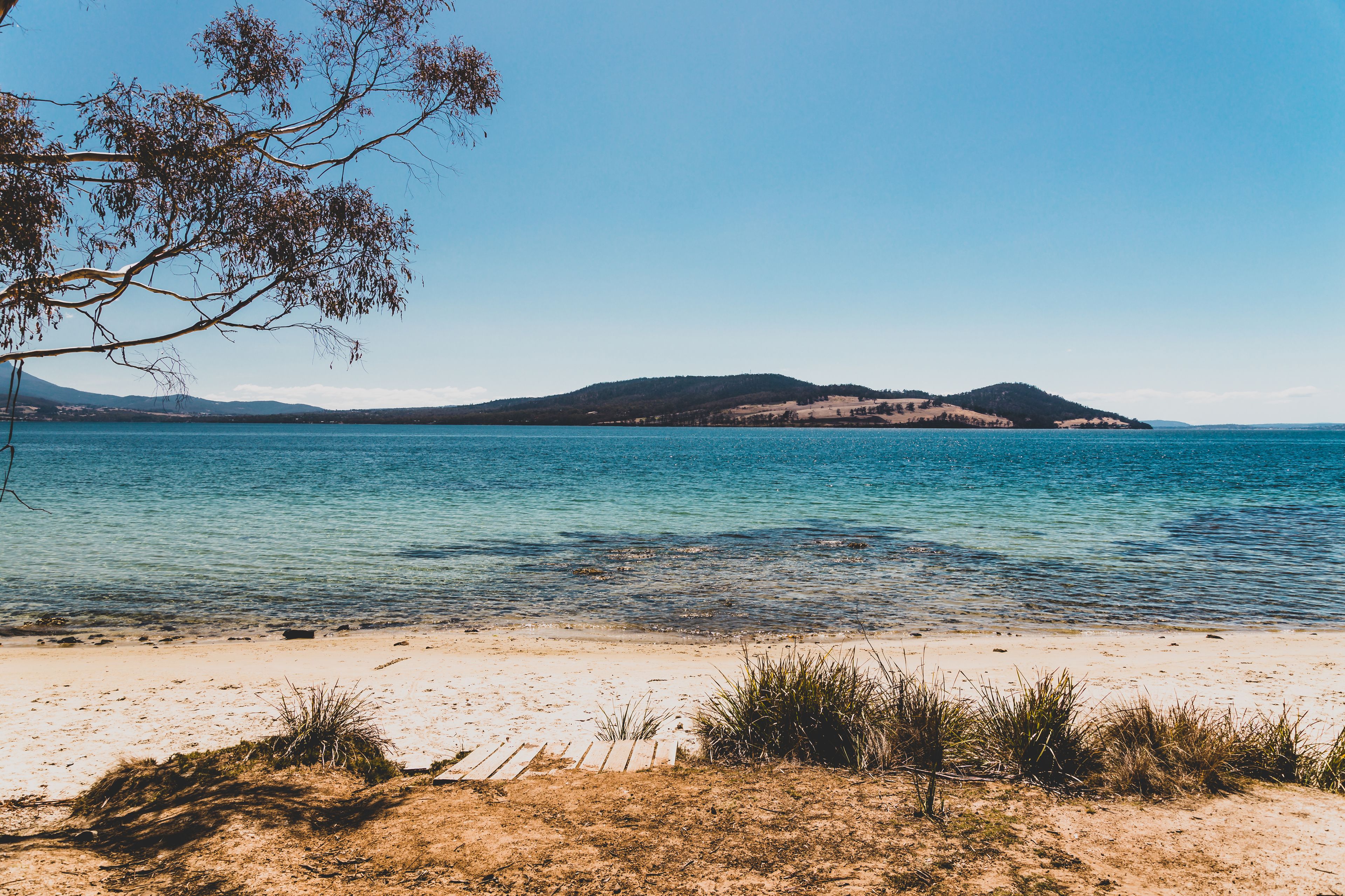 wild Tasmanian landscape and pristine turquoise water of the Derwent River as seen from Legacy Beach near Coningham beach south of Hobart