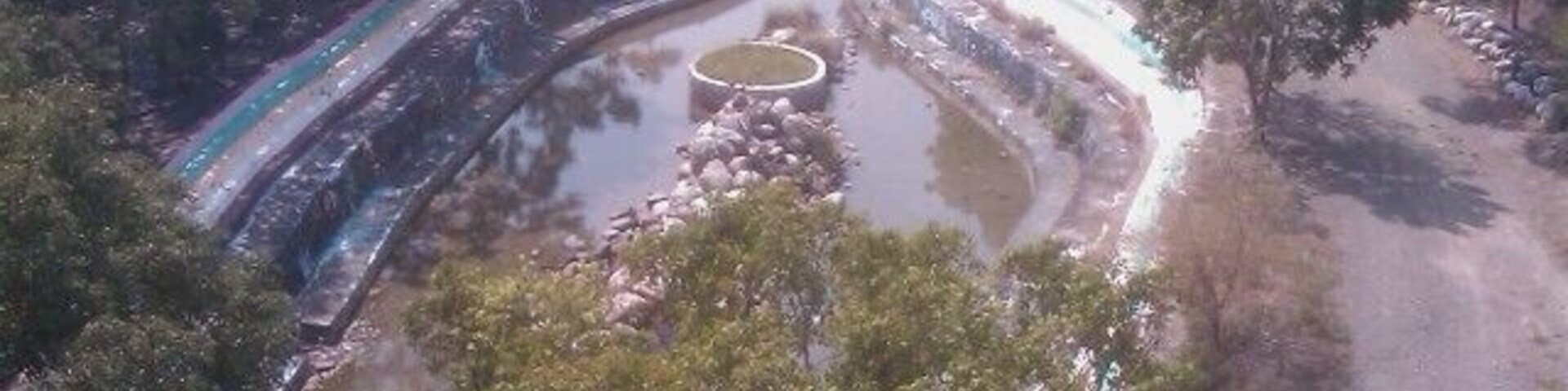 A river with a winding path and a circular water feature.