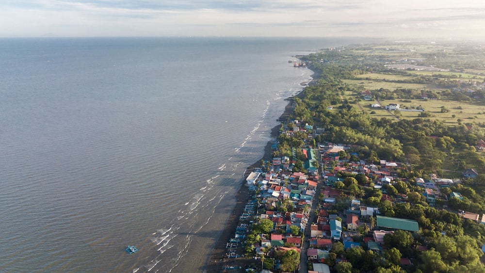 Aerial of the coastline of Naic Cavite Philippines. Early morning drone shot.