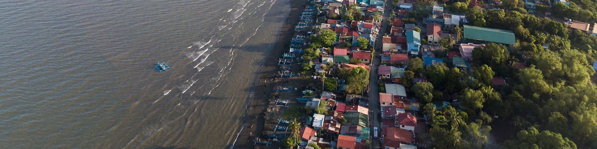 Aerial of the coastline of Naic Cavite Philippines. Early morning drone shot.