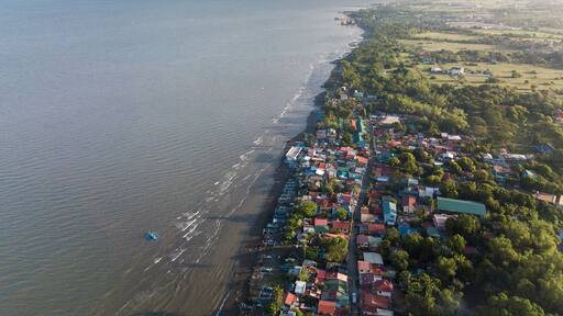 Aerial of the coastline of Naic Cavite Philippines. Early morning drone shot.