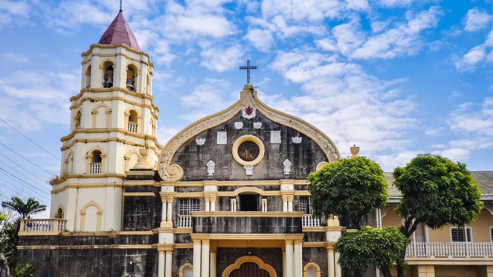 A historic church with a bell tower and a large dome.
