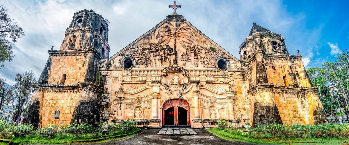 A historic church with ornate carvings and two bell towers.