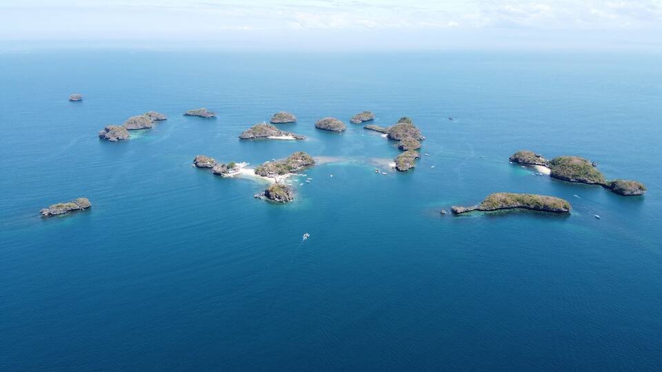 A group of small islands surrounded by clear blue water.