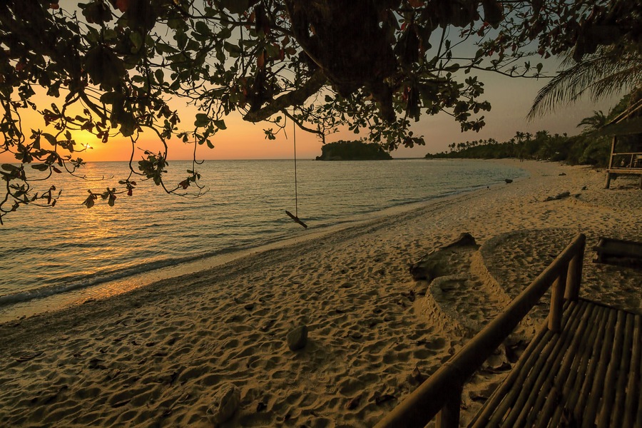 Sipping a beer and watching the sun go down couldn't get any better in Binucot Beach in Ferrol, Romblon, Philippines.