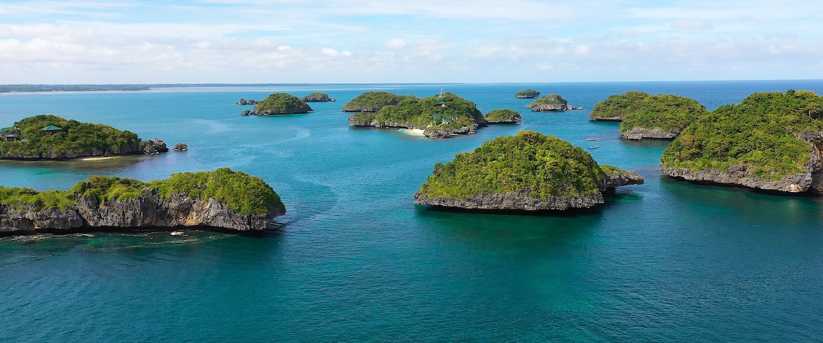 A group of lush green islands surrounded by turquoise waters.