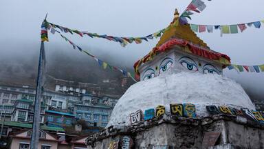 A chhorten in Namche Bazaar with angular view of Namche.